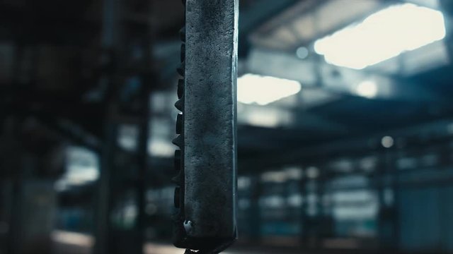 Close up shot of a swinging remote controller on abandoned factory. Scary, catastrophe, horror concept. Blackmagic URSA Mini RAW graded footage