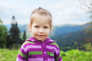 little girl traveling in mountains