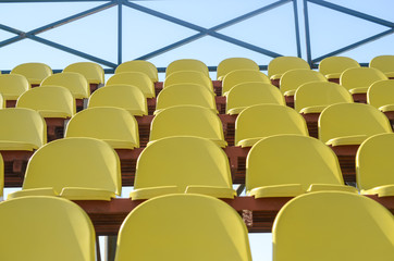 Fototapeta premium Rows of yellow plastic seats in the stadium