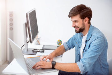 Contented man using his laptop