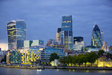 LONDON, UK - SEPTEMBER 19, 2015: City of London office buildings at sunset and first night lights