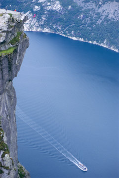 Man making a base jump, involving the use of a parachute.