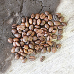 Coffee beans on old wooden background.