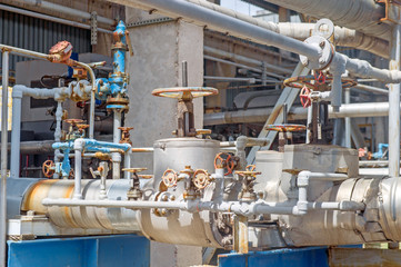 Industrial equipment and pipelines at the gas processing plant on a summer day