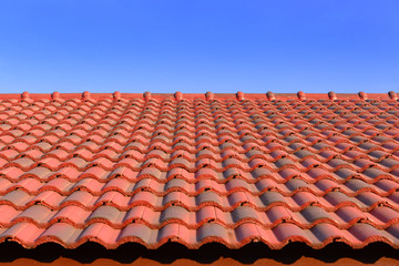 the red ceramic roof tile with sun light and blue sky,red ceramic roof tils and sunlight with the wide screen frame