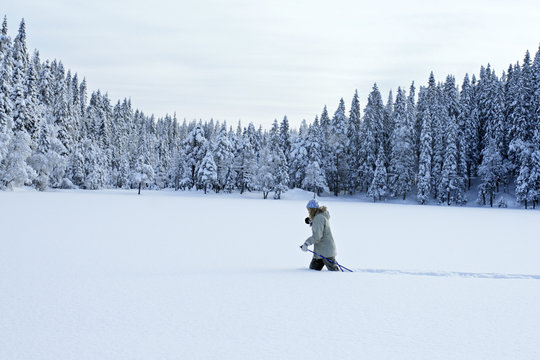 Skier walking on snowy field