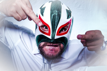 Shocked, angry businessman with Mexican wrestler mask, expressio