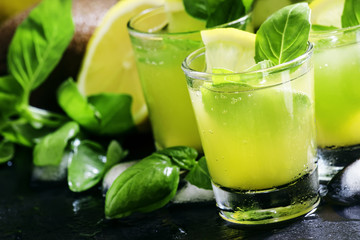 Spicy fruit lemonade with basil, kiwi, lemon, soda and ice, blac