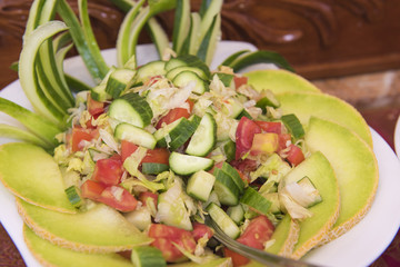Salad dish with melon on a white plate