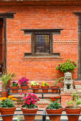 Fototapeta na wymiar Carved wooden window on a brick wall