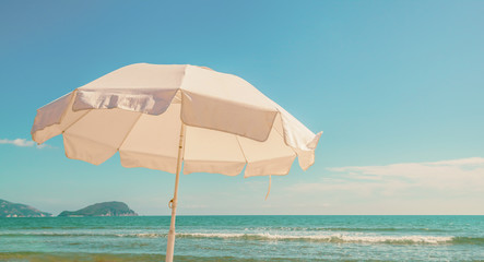 Umbrella on tropical beach hot summer day