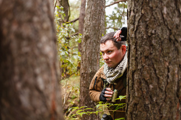 Man with binoculars at a forest