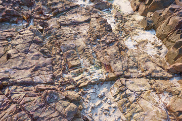 Sea waves crashing over rocks on stone beach.Sea waves beating a