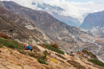 Fototapeta premium Female trekker enjoying a mountain panorama.