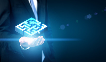 Businessman holding maze