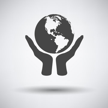 Hands holding planet icon on gray background with round shadow. Vector illustration.