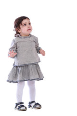 Portrait of little girl in grey clothes on a white background