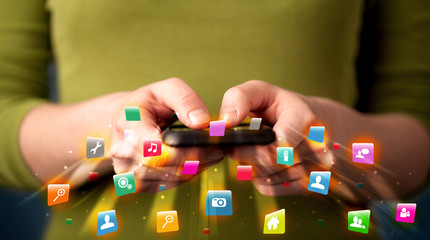 Man holding smartphone with technology application icons