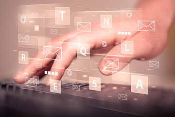 Hand typing on keyboard with digital tech icons