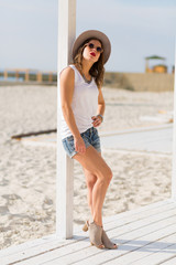 Stylish woman at the summer beach in a hot day