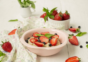 Porridge with berries - strawberries and blueberries
