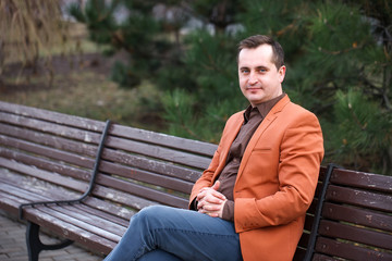 Fototapeta premium 40+ man with a problem of baldness is sitting on the bench.