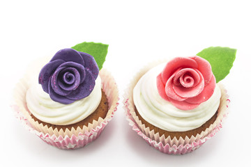 Cupcakes decorated with roses on a white background
