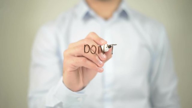 Don't Panic , man writing on transparent screen