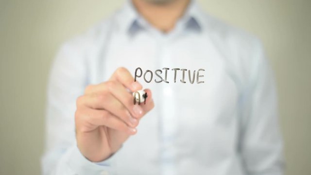 Positive Attracts Positive , man writing on transparent screen