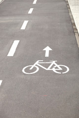 Asphalt road for bikes in a city park in summer day closeup