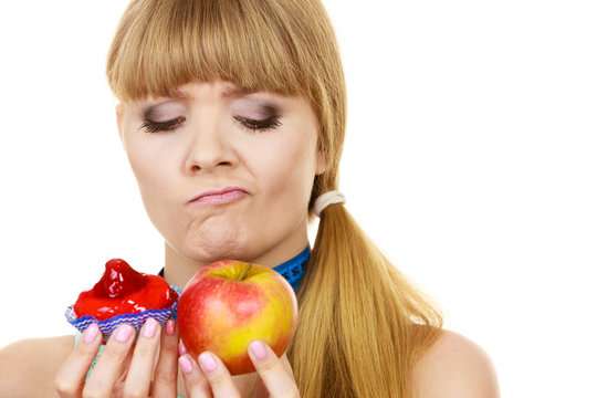 Woman choosing fruit or cake make dietary choice