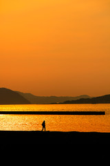 Man walk on sunset beach