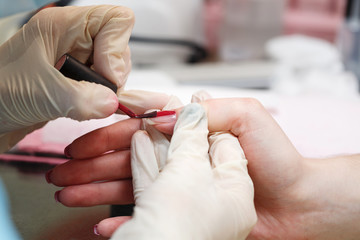 Manicure. Covering nail varnish color.