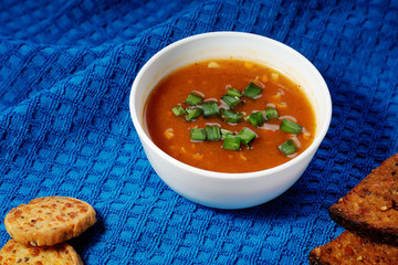 Goulash soup and sliced bread on a  towel