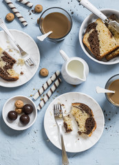 Breakfast or snack table - coffee, cookies, candy, cake, cream on a blue stone  background