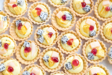 Cupcakes decorated with fresh fruits. pitaya, pineapple and melon.
