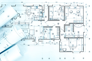 architects workspace with blueprint rolls and technical drawings