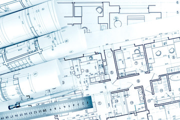 rolls of architectural drawings with pencil and ruler