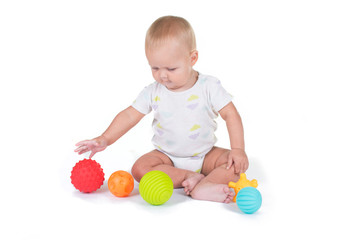Fototapeta na wymiar Adorable baby playing with a colorful beach ball, isolated on white