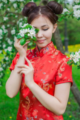 Obraz premium Beautiful asian girl in traditional chinese red dress.