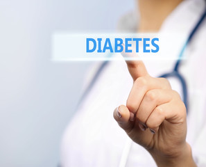 Young female doctor pointing finger on text diabetes