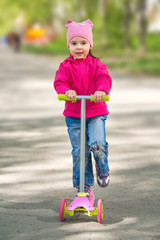 little girl riding a scooter © Alexander Gogolin