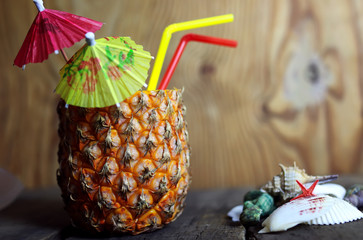 pineapple with straw wooden background