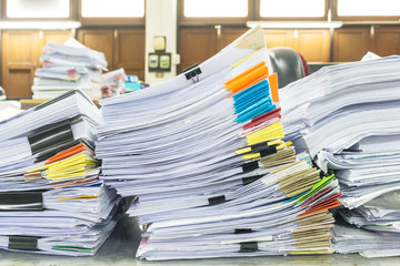 Pile of documents with colorful clips on desk stack up