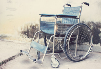 Vintage,Old Wheelchairs with wall background