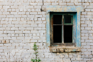 Fototapeta na wymiar Window of ruined brick house