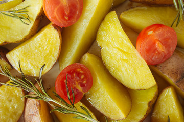 Baked potatoes with cherry tomatoes closeup