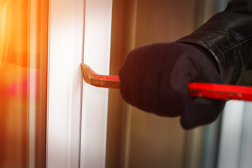 Burglar breaking in a house