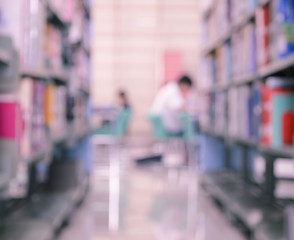 Blurred abstract background of library with bookshelves and read