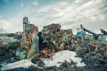 Apocalyptic landscape.The remains of destroyed houses covered with snow